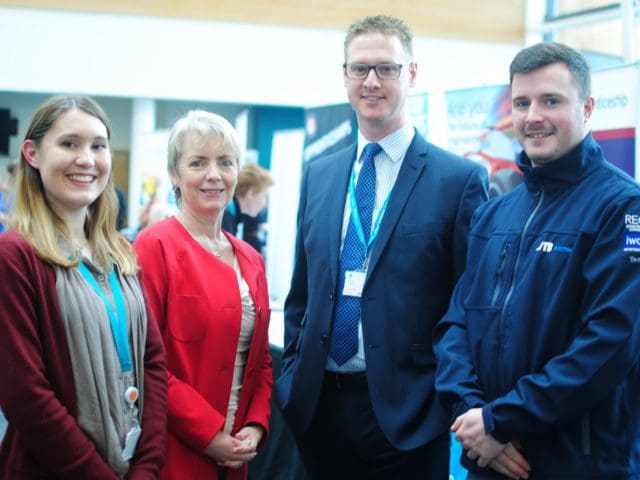 MP Karin Smyth, Lee Probert, Principal and Chief Executive for , and two students stand in-front of a jobs fair displays